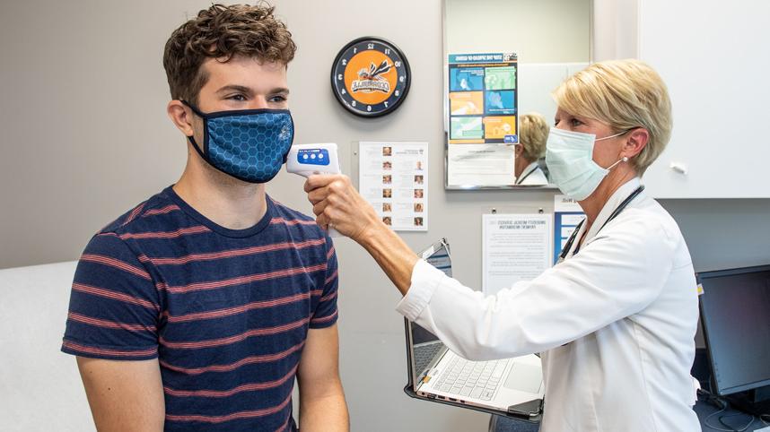 Nurse taking student's temperature at UMS