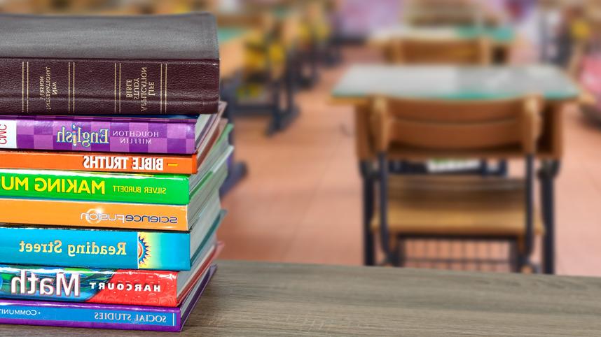 Stack of schoolbooks with Bible on top