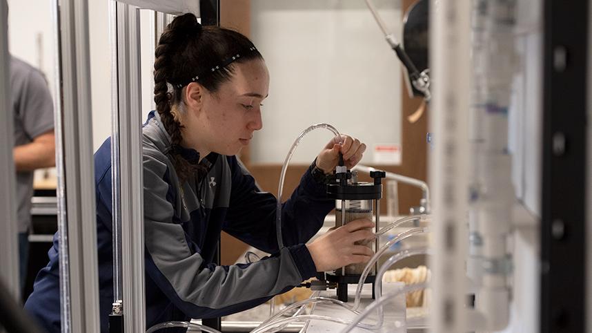 An engineering student works on a mechanism